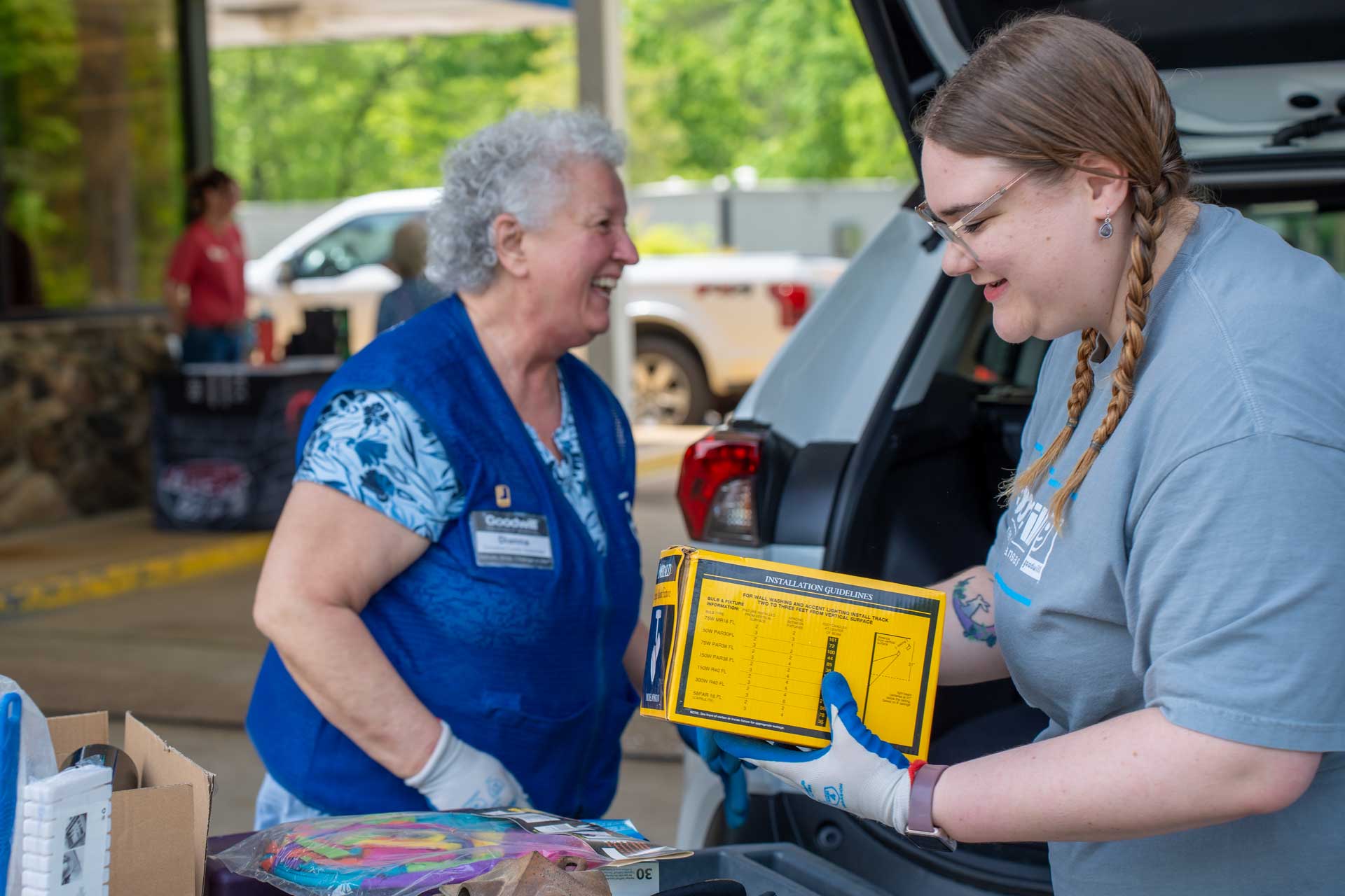 Donation drives 3 Volunteers helping unload vehicles of donated goods