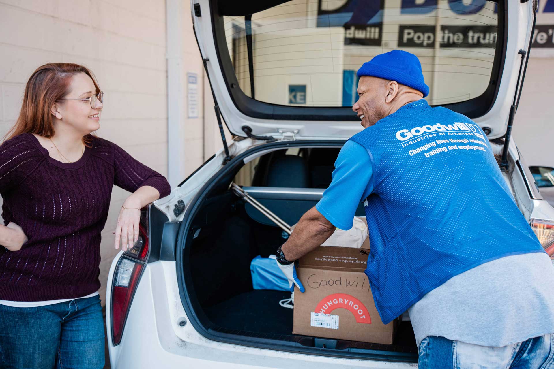 Goodwill mythbusters 3 Smiling employee unloading the trunk of a car