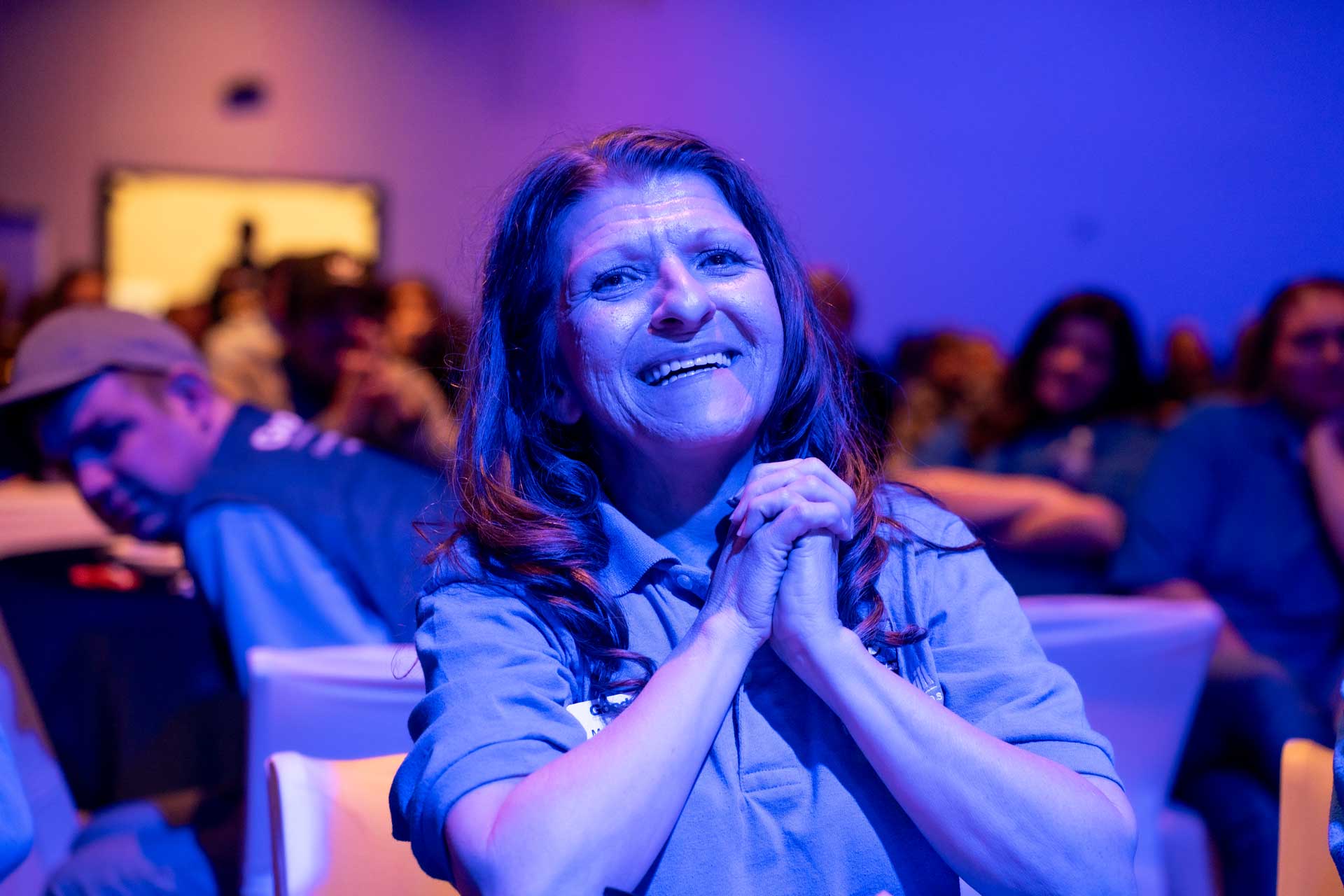 Sustainability 16 Woman grasping her hands in delight at goodwill event